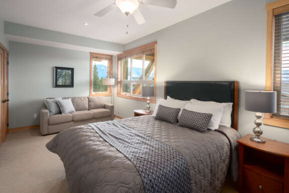 Queen bedroom with queen bed, bedside tables and lamps