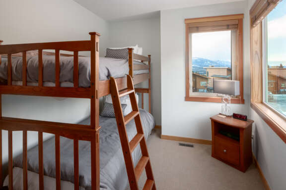 Bunk beds with two twin beds, window to the right.