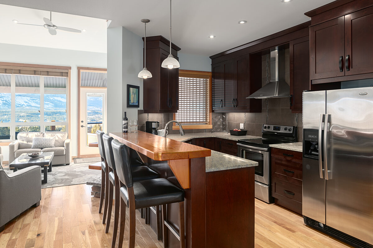 Spacious kitchen with island, barstools, and modern appliances.