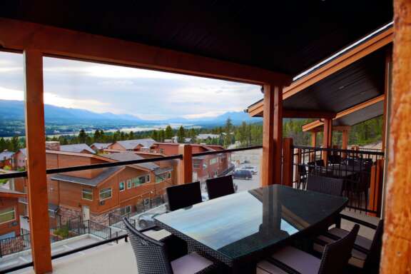 Outdoor deck with seating area and patio furniture, table and chairs.