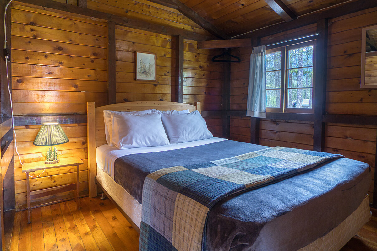 Queen bedroom in wood panelled cabin