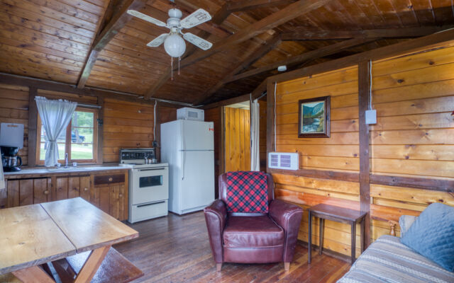 Outdoor living space with two red chairs and greenery.