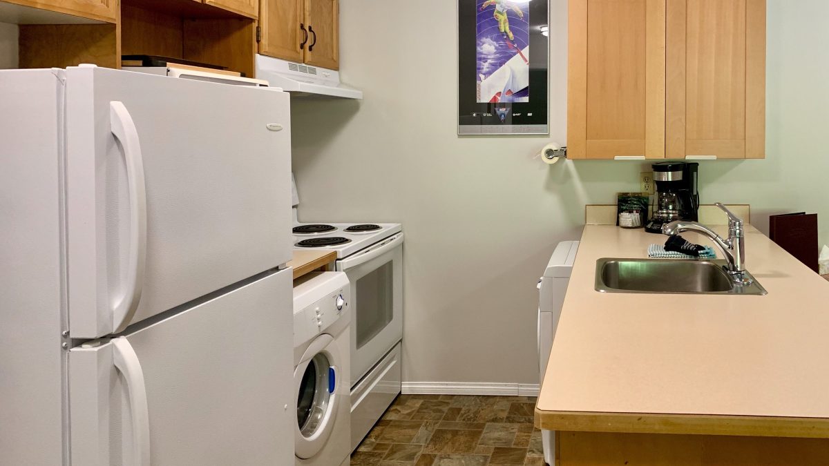 Small kitchen with fridge, appliances, and counterspace.