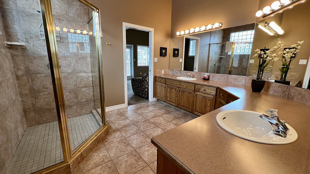 Ensuite bathroom with shower and large vanity.