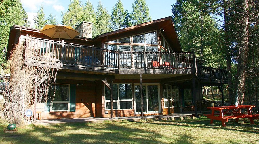 Large cabin with open concept. Surrounded by greenery and trees.