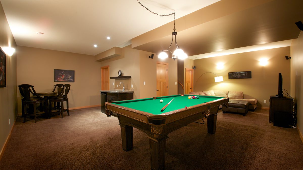 Living space with pool table, wet bar, and seating.