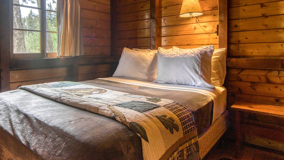Double bedroom in wood panelled cabin