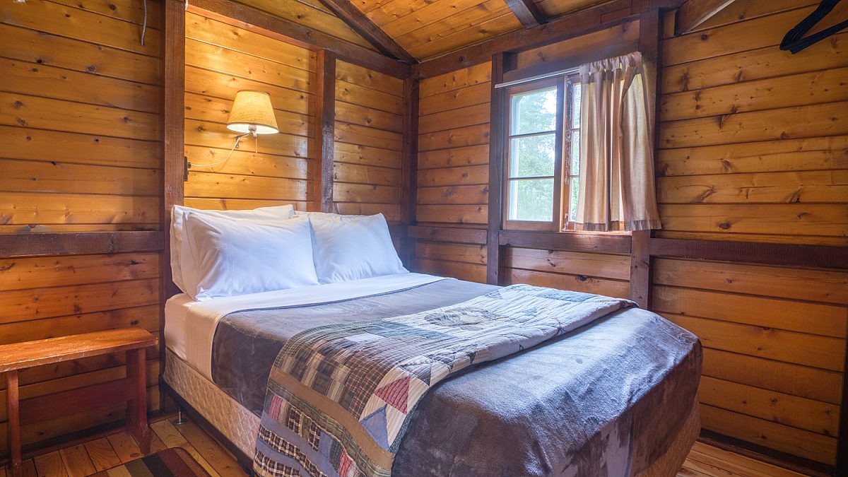 Double bedroom in wood panelled cabin