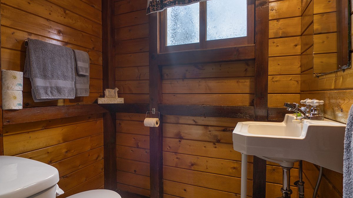 Bathroom area in wood panelled cabin.