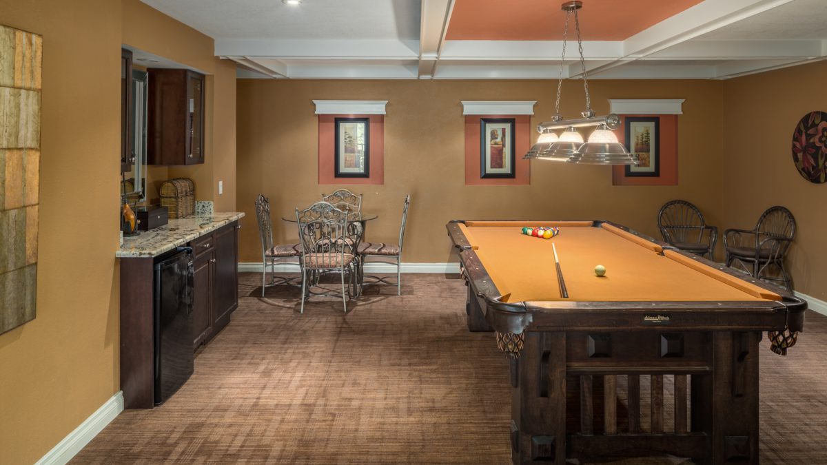 Recreation room with pool table, wet bar, and seating areas.
