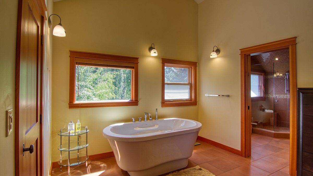 Bathroom with a standalone soaker tub, two windows ensuite to the master bedroom.