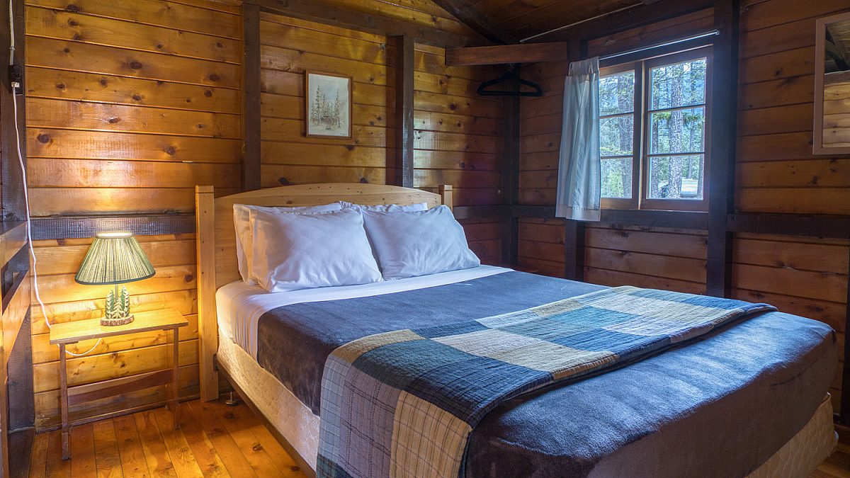 Queen bedroom in wood panelled cabin